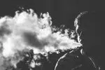 grayscale photography of smoking man