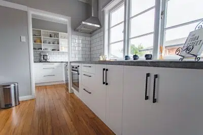 white wooden kitchen cabinet near window