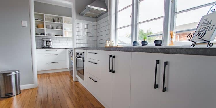 white wooden kitchen cabinet near window