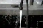 a faucet running water from a kitchen sink