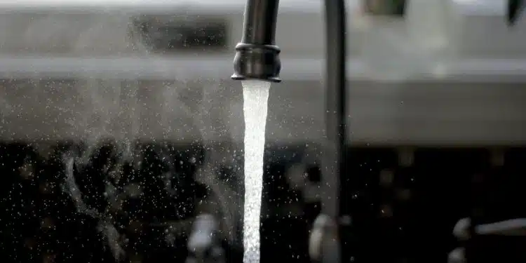 a faucet running water from a kitchen sink